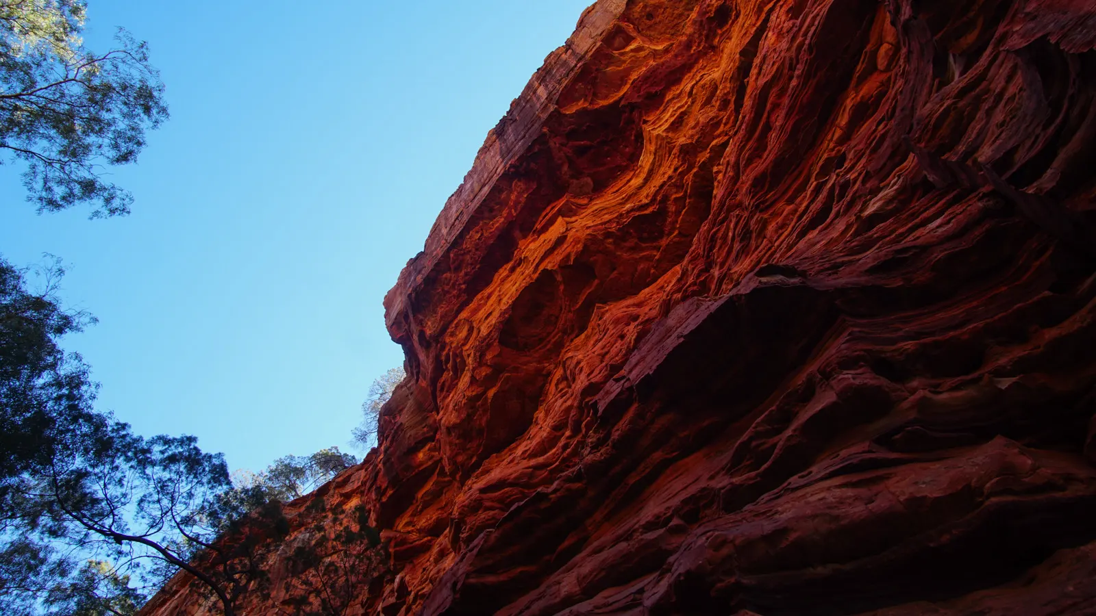 Vivid red sandstone walls and blue sky.